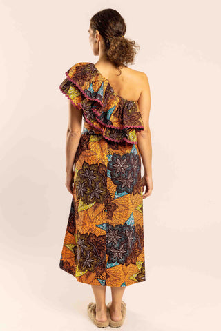 A sophisticated and feminine dress that screams 'Africa'! 100% made in South Africa from pure cotton, this Midi long dress features a rather tight fit at the waist that flares out over the skirt, thanks to a matching wrap around belt. It has side splits and ric-rac trim. What makes it unique are the tribal pattern it features and the off shoulder detail, the two frills make it extremely playful and perfect for your everyday life. 