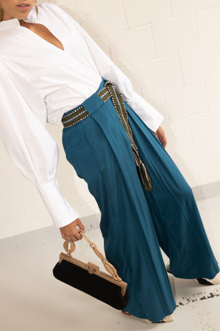 These wide-leg pants from By Adushka are made from pure silk. They feature pressed pleats and side pockets and they are cut to a mid-rise waist with wide legs for comfort and ease without compromising on style. A detail that we absolutely love about these pants are the two frontal belt loops, which allow you to play with this accessory despite the fact that the waist is elasticated. 