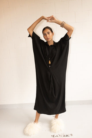 Fill your getaway suitcase with pieces from By Adushka, like this black Barcellona dress. Made in Italy from 100% silk, it falls slightly on the body, fitting perfectly to any body type. It features a decent collar v-neckline and it's cut to a relaxed design with batwing sleeves with elastic closure and a comfort-ensuring lining. 
