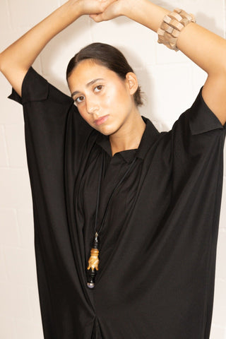Fill your getaway suitcase with pieces from By Adushka, like this black Barcellona dress. Made in Italy from 100% silk, it falls slightly on the body, fitting perfectly to any body type. It features a decent collar v-neckline and it's cut to a relaxed design with batwing sleeves with elastic closure and a comfort-ensuring lining. 