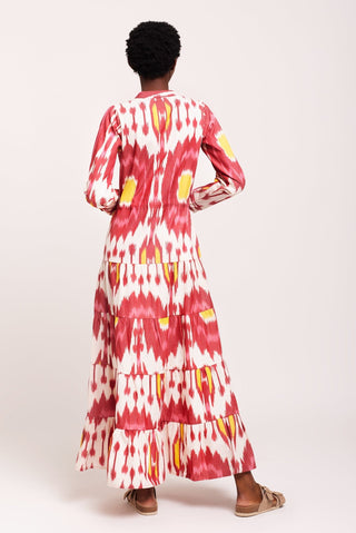 An instant hit, this Strawberry Pole-Pole from Kleed, ushering in the warm summer days and tropical evenings. A supremely flattering combination of berry crush and peachy pink, with irresistible sherbet yellow accents. We love the light single IKAT fabric, tapered line, elegant Mandarin collar, gathered sleeves buttoned at the cuff and gently flaring, four-tier flounces.