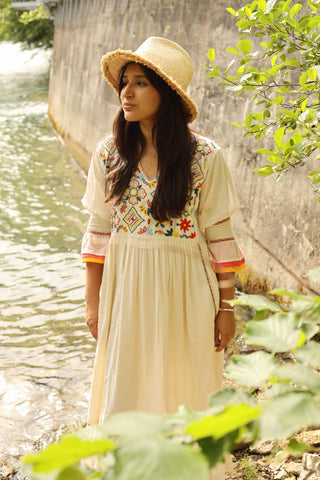 This absolute stunning bohemian dress from Santa Lupita is a safe bet to get full of compliments Summer after Summer. Its long and airy wide-cut skirt swings all around you and invites you to dance and sense the freedom. The multi-layered cuffs and the multicolored embroideries radiate joy and reminds us of blooming flowers.